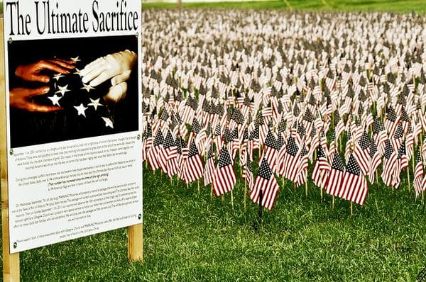 The Ultimate Sacrifice sign with American Flags