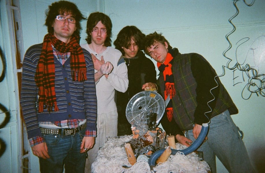 Fib Band group photo with four men and a spinning fan