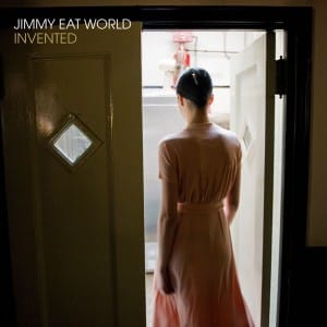 Jimmy Eat World Invented Album Cover with a woman in a light pink dress walking into a kitchen through double doors