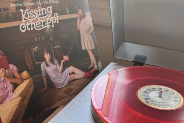 When Folk Gets Weird (In the Best Way): kissing other ppl by Rachel Baiman + Viv & Riley Kissing Other PPl album cover and red vinyl record on player