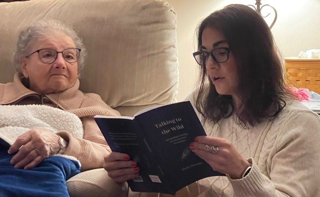 Grandmom WIlley sitting with Christy as she reads a poem on Christmas Eve 2024