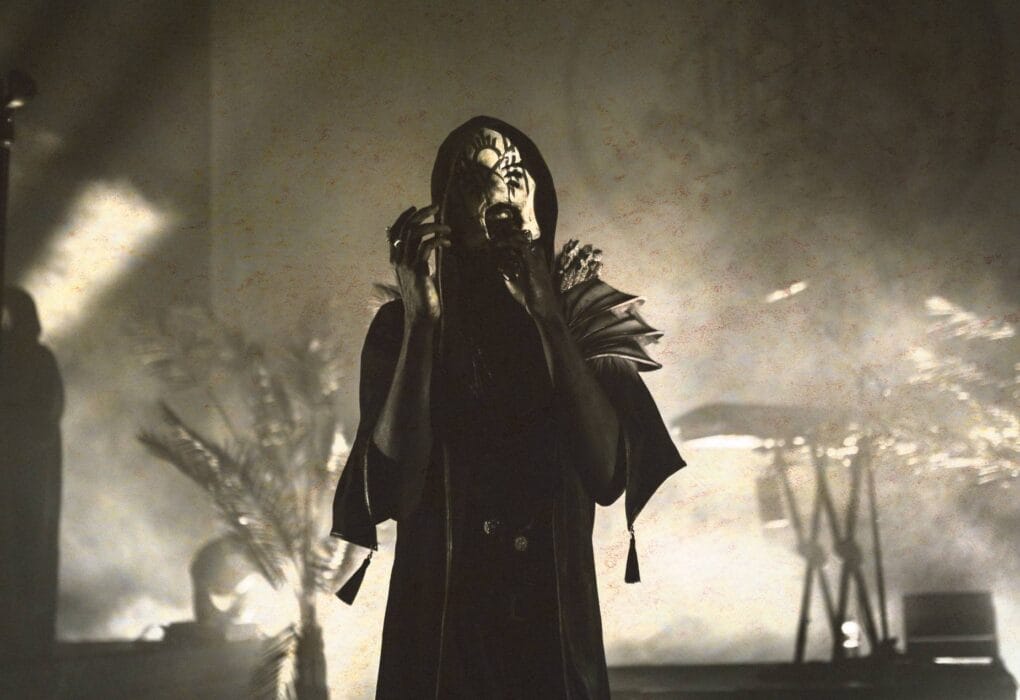 Sleep Token on stage in mask and black cloak