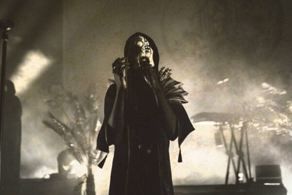 Sleep Token on stage in mask and black cloak